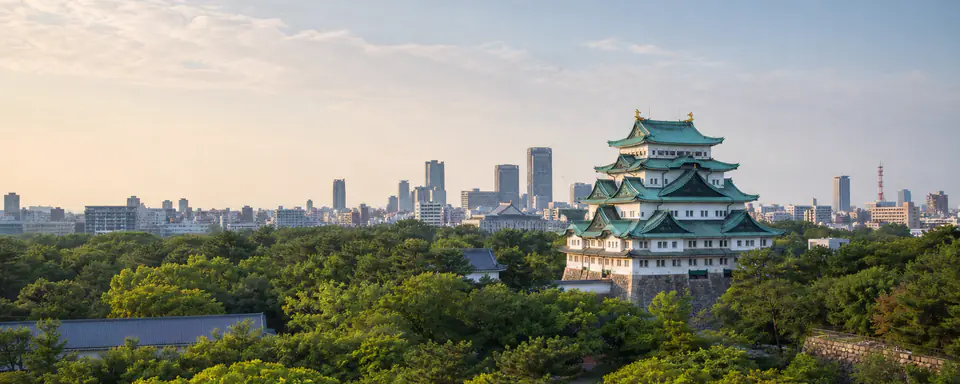 Illustrated view of Nagoya Castle surrounded by greenery with the city's modern skyline in the background