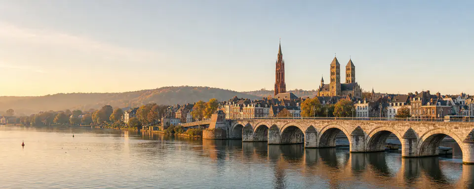 Illustrated panorama of Maastricht on the Maas with its stone bridge and historic city skyline