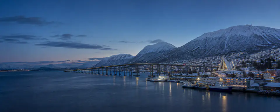 Illustrated blue-hour view of Tromsø Sound with the bridge, Arctic Cathedral, and snow-covered mountains