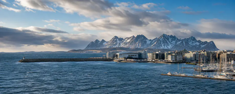 Illustrated view of Bodø's harborfront with a marina, choppy sea, and snow-streaked coastal mountains