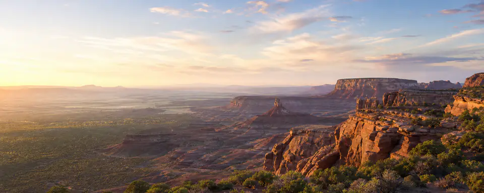 Illustrated American desert plateau landscape with red cliffs in warm evening light